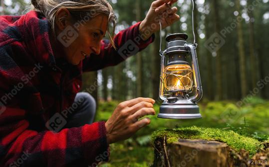 Female Hiker ignite a kerosene lamp or oil lamp in the forest. authentic close-up shot. Travel concept image  : Stock Photo or Stock Video Download rcfotostock photos, images and assets rcfotostock | RC Photo Stock.: