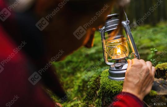 Female Hiker using a kerosene lamp or oil lantern in the dark forest  : Stock Photo or Stock Video Download rcfotostock photos, images and assets rcfotostock | RC Photo Stock.: