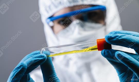 female medical or scientific researcher or woman doctor looking at a test tube of clear solution in a laboratory  : Stock Photo or Stock Video Download rcfotostock photos, images and assets rcfotostock | RC Photo Stock.: