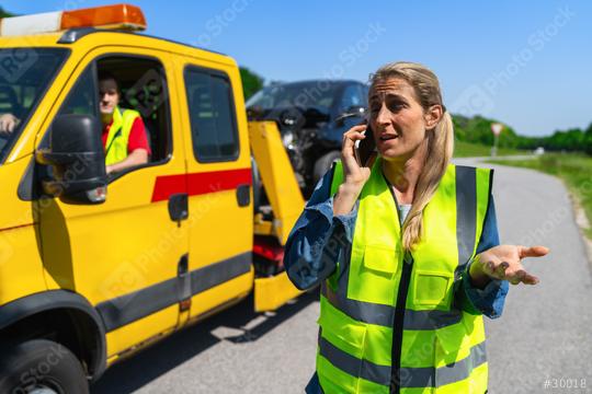female motorist Gesticulating and talks on the phone after the towing service has loaded her car onto a Tow truck and explains her problem. Roadside assistance concept image.  : Stock Photo or Stock Video Download rcfotostock photos, images and assets rcfotostock | RC Photo Stock.: