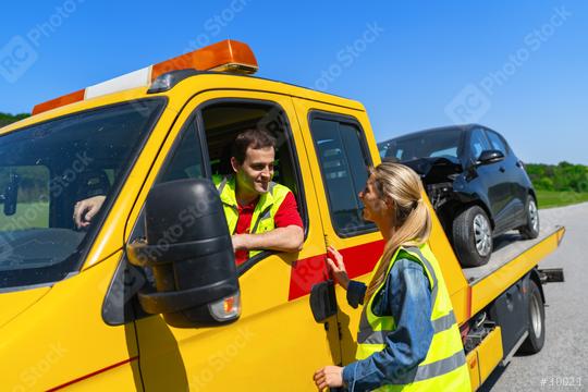 female motorist talking to tow truck driver with damaged car on flatbed  : Stock Photo or Stock Video Download rcfotostock photos, images and assets rcfotostock | RC Photo Stock.: