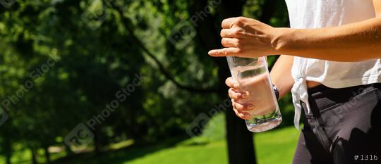 Female runner holding bottle of water. Drinking water concept. copyspace for your individual text. banner size  : Stock Photo or Stock Video Download rcfotostock photos, images and assets rcfotostock | RC Photo Stock.: