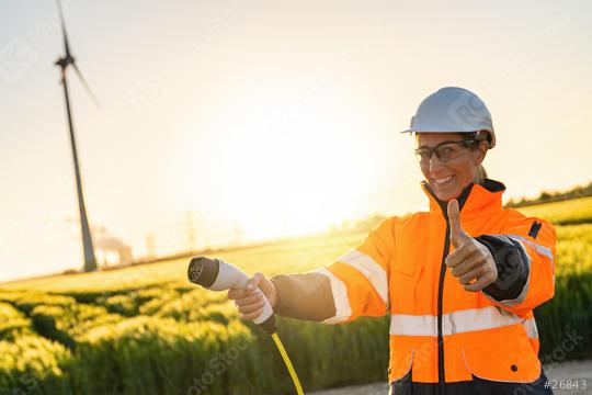 Female Work woman standing  outside and holding power cable to c  : Stock Photo or Stock Video Download rcfotostock photos, images and assets rcfotostock | RC Photo Stock.: