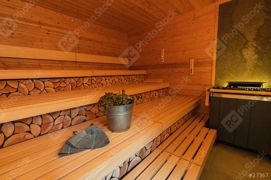 finnish sauna interior with stacked wood, benches, a sauna bucket, vihta (birch whisks), and felt hats  : Stock Photo or Stock Video Download rcfotostock photos, images and assets rcfotostock | RC Photo Stock.: