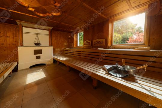 Finnish sauna with tiled floor, wooden benches, stove, towel, metal bucket, ladle, and felt hats with window with a view in a spa hotel  : Stock Photo or Stock Video Download rcfotostock photos, images and assets rcfotostock | RC Photo Stock.: