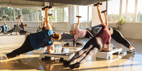 Fitness class performing side plank with dumbbells, sunlit gym, mirror reflection  : Stock Photo or Stock Video Download rcfotostock photos, images and assets rcfotostock | RC Photo Stock.: