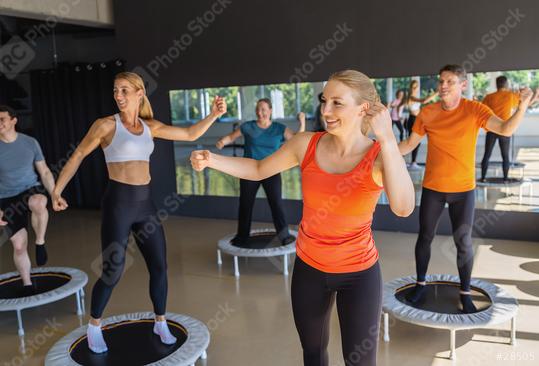 Fitness class with people exercising on mini trampolines in a gym, smiling and energetic  : Stock Photo or Stock Video Download rcfotostock photos, images and assets rcfotostock | RC Photo Stock.: