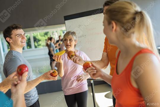 Fitness group discussing nutrition holding fruits with a whiteboard in the background  : Stock Photo or Stock Video Download rcfotostock photos, images and assets rcfotostock | RC Photo Stock.: