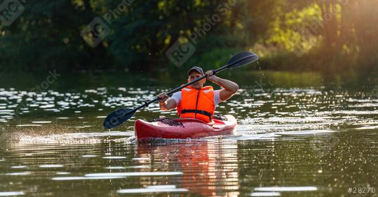 Focused man in a red kayak on a sparkling river, paddling with concentration in the evening light in germany. Kayak Water Sports concept image  : Stock Photo or Stock Video Download rcfotostock photos, images and assets rcfotostock | RC Photo Stock.: