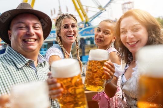 Four friends cheerfully toasting with large beer mugs at a vibrant Oktoberfest or dult in germany  : Stock Photo or Stock Video Download rcfotostock photos, images and assets rcfotostock | RC Photo Stock.: