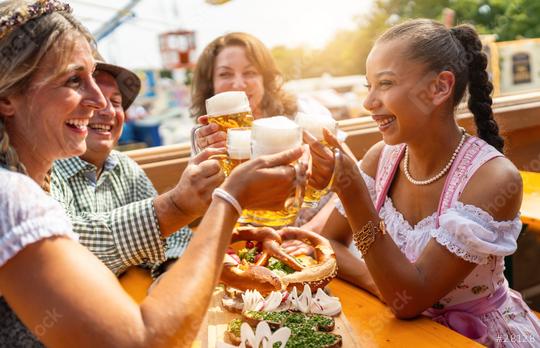 Four friends in beer tent at Dult or Oktoberfest toasting with beer mugs up in the air  : Stock Photo or Stock Video Download rcfotostock photos, images and assets rcfotostock | RC Photo Stock.: