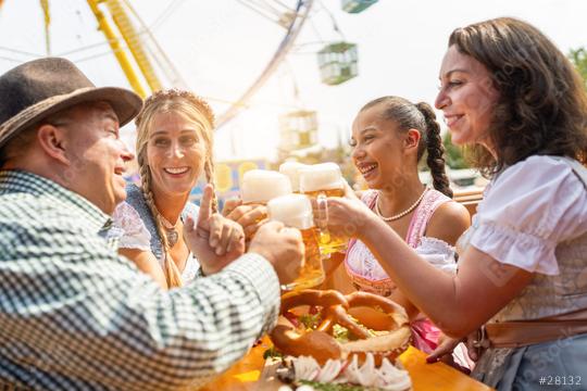 friends in Tracht, Dirndl and Lederhosen sitting in beer tend in front of a Ferris wheel at Oktoberfest or Dult in germany  : Stock Photo or Stock Video Download rcfotostock photos, images and assets rcfotostock | RC Photo Stock.: