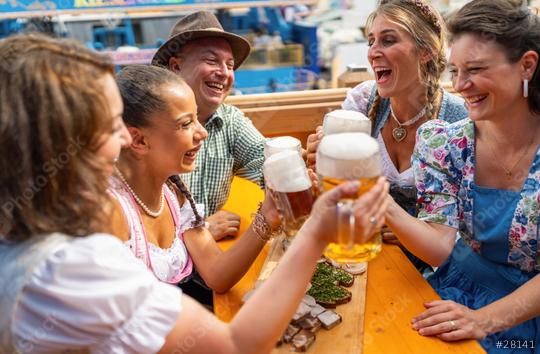 Friends laughing and toasting with beer mugs at a lively Oktoberfest  or dult, joyful atmosphere at bavarian beer tent  : Stock Photo or Stock Video Download rcfotostock photos, images and assets rcfotostock | RC Photo Stock.: