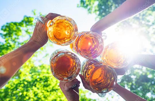 Friends toasting and drinking beer at Oktoberfest, having fun and clinking beer mugs in a Beer garden in summer time, Munich, Germany  : Stock Photo or Stock Video Download rcfotostock photos, images and assets rcfotostock | RC Photo Stock.: