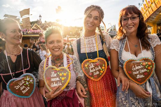 Friends visiting together Bavarian oktoberfest in Dirndl with Schenk mir dein Herz, Für mein Schatz, Ich hab dich lieb (German: Give me your heart, For my sweetheart) written on gingerbreads heart  : Stock Photo or Stock Video Download rcfotostock photos, images and assets rcfotostock | RC Photo Stock.: