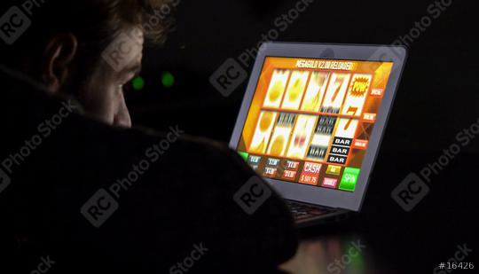 Gambling addicted man with glasses in front of online casino slot machine on laptop computer at night - loosing his money. Dramatic low light grain shot.  : Stock Photo or Stock Video Download rcfotostock photos, images and assets rcfotostock | RC Photo Stock.: