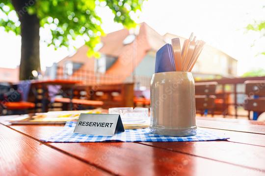 german beer garden table with reserved table sign with places setting at summer  : Stock Photo or Stock Video Download rcfotostock photos, images and assets rcfotostock | RC Photo Stock.: