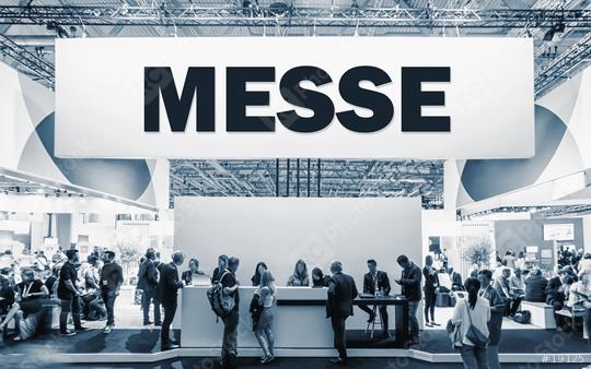 German text Messe, translate Trade Show. Crowd of people at a trade show booth with a banner and text  : Stock Photo or Stock Video Download rcfotostock photos, images and assets rcfotostock | RC Photo Stock.: