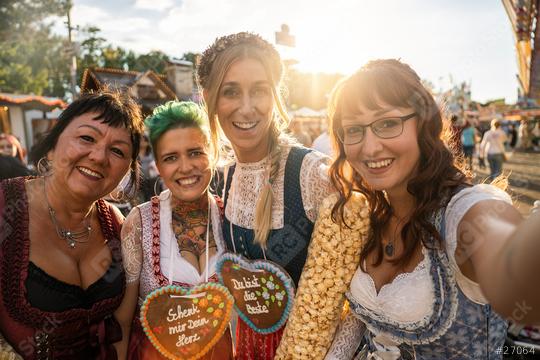 Girlfriends in traditional Bavarian clothes dirndl or tracht with Schenk mir dein Herz, Du bist die beste (German: Give me your heart, you are best ) written on gingerbreads heart on Oktoberfest  : Stock Photo or Stock Video Download rcfotostock photos, images and assets rcfotostock | RC Photo Stock.: