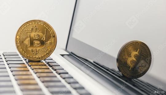 Golden Bitcoin - New virtual money on notebook  : Stock Photo or Stock Video Download rcfotostock photos, images and assets rcfotostock | RC Photo Stock.:
