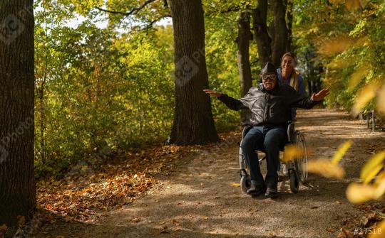 grandfather in a wheelchair, dressed as an aviator, joyfully extends his arms surrounded by colorful autumn trees  : Stock Photo or Stock Video Download rcfotostock photos, images and assets rcfotostock | RC Photo Stock.: