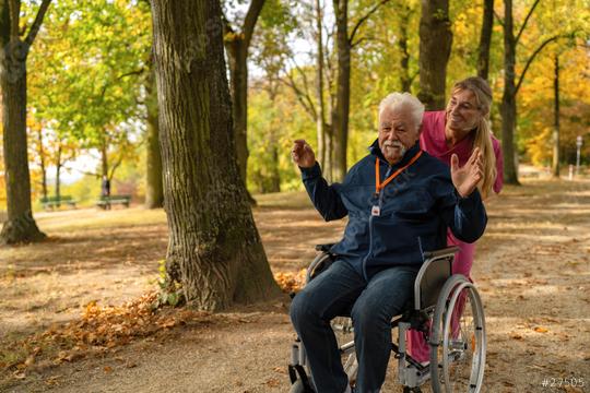 grandfather in wheelchair with nurse in park, autumn setting, wearing a SOS button for safety  : Stock Photo or Stock Video Download rcfotostock photos, images and assets rcfotostock | RC Photo Stock.: