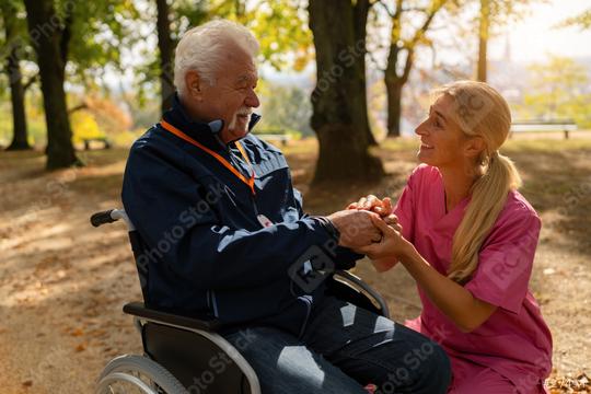 grandfather with a caregiver in a park, smiling and holding hands, man wearing an SOS button. Dementia retirement home concept image  : Stock Photo or Stock Video Download rcfotostock photos, images and assets rcfotostock | RC Photo Stock.: