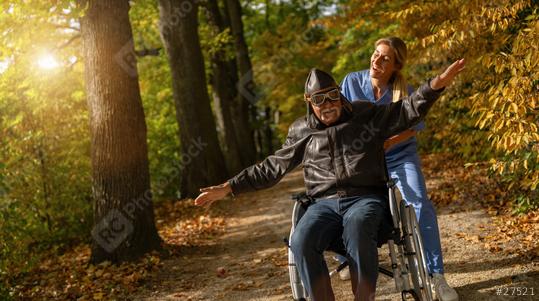 grandpa in an aviator outfit and goggles having fun in a wheelchair, with a nurse in a park, both happy. nursery home concept image   : Stock Photo or Stock Video Download rcfotostock photos, images and assets rcfotostock | RC Photo Stock.: