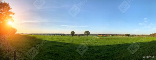 Green field with trees and blue sky. Panoramic view to grass, trees and flowers on the hill on sunny spring day  : Stock Photo or Stock Video Download rcfotostock photos, images and assets rcfotostock | RC Photo Stock.: