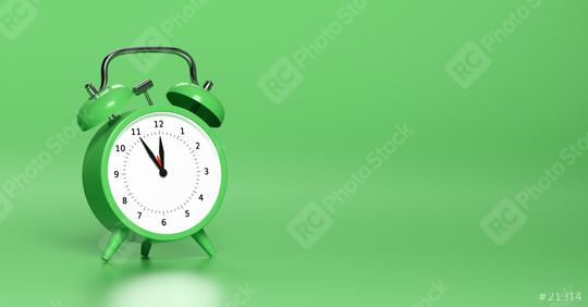 Green vintage alarm clock point to five minutes to twelve o