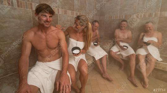 Group of adults, draped in white towels, relaxes in a tiled steam bath. A woman applies salt from a bowl on the shoulder from her boyfriend. wellness and spa concept image  : Stock Photo or Stock Video Download rcfotostock photos, images and assets rcfotostock | RC Photo Stock.: