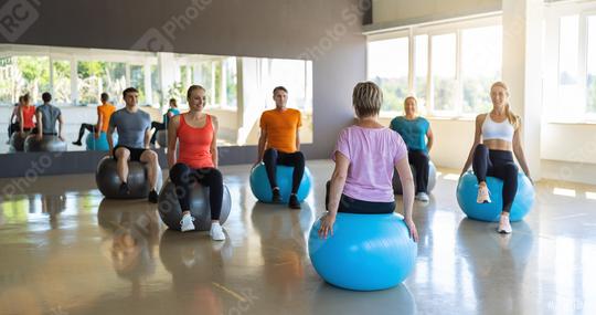 Group of diverse people from behind in a receding line doing pilates in a gym balancing on the gym balls toning their muscles. Healthy sports lifestyle, Fitness, Healthy concept.  : Stock Photo or Stock Video Download rcfotostock photos, images and assets rcfotostock | RC Photo Stock.: