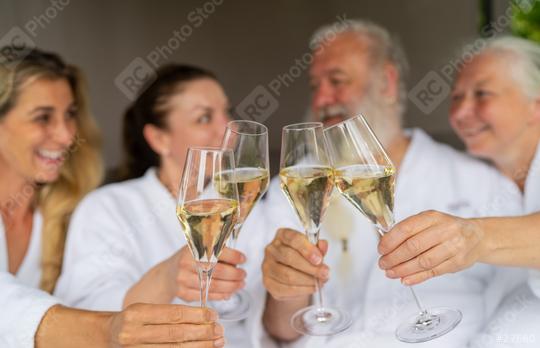 Group of four people in white bathrobes toasting with champagne glasses and celebrating a event in a spa wellness hotel  : Stock Photo or Stock Video Download rcfotostock photos, images and assets rcfotostock | RC Photo Stock.: