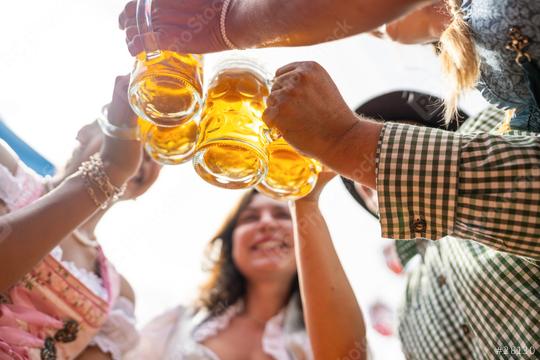 Group of friends joyfully toasting with beer mugs under a bright sky at Oktoberfest or Dult in germany  : Stock Photo or Stock Video Download rcfotostock photos, images and assets rcfotostock | RC Photo Stock.: