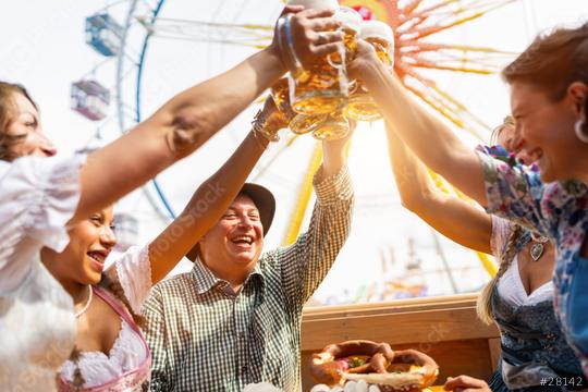 Group of friends toasting with beer mugs at an outdoor festival, joyful expressions, ferris wheel in background at oktoberfest or dult in germany  : Stock Photo or Stock Video Download rcfotostock photos, images and assets rcfotostock | RC Photo Stock.: