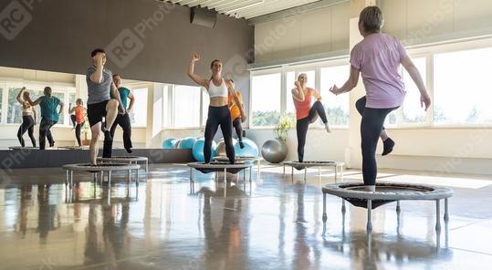 Group of people exercising on mini trampolines in a bright fitness studio  : Stock Photo or Stock Video Download rcfotostock photos, images and assets rcfotostock | RC Photo Stock.: