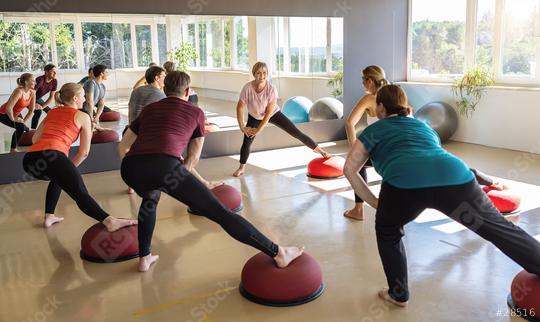 Group of people stretching on Bosu Balls in a fitness class with large windows  : Stock Photo or Stock Video Download rcfotostock photos, images and assets rcfotostock | RC Photo Stock.: