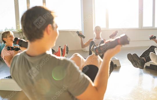 Gym class doing seated dumbbell exercises, sunlit room, joyful atmosphere  : Stock Photo or Stock Video Download rcfotostock photos, images and assets rcfotostock | RC Photo Stock.: