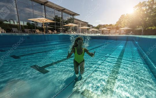 Half underwater split image of a woman swimming in swimming pool at a hotel or spa resort  : Stock Photo or Stock Video Download rcfotostock photos, images and assets rcfotostock | RC Photo Stock.: