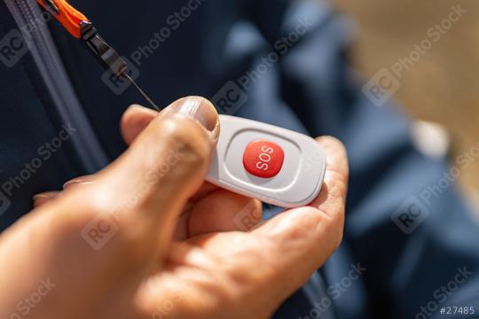 hand activating a red SOS emergency button on a safety device, attached to a jacket with an orange lanyard. Dementia retirement home concept image  : Stock Photo or Stock Video Download rcfotostock photos, images and assets rcfotostock | RC Photo Stock.: