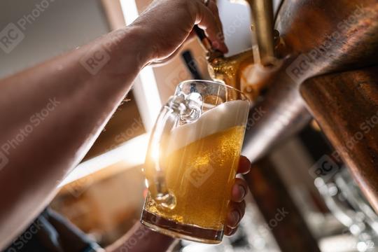 Hand holding a beer glass being filled from a tap, with a focus on the beer and foam  : Stock Photo or Stock Video Download rcfotostock photos, images and assets rcfotostock | RC Photo Stock.: