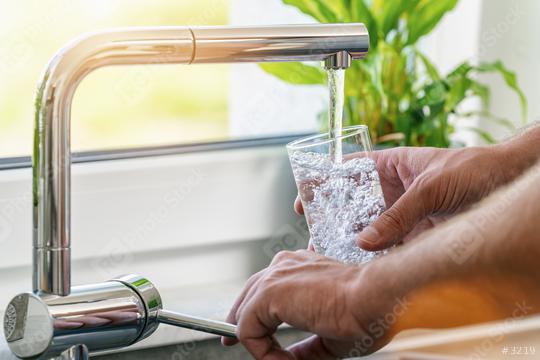 Hand holding a glass of water poured from the kitchen faucet  : Stock Photo or Stock Video Download rcfotostock photos, images and assets rcfotostock | RC-Photo-Stock.: