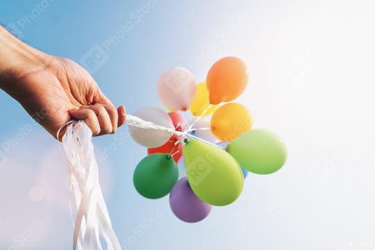 hand holding Colorful balloons  : Stock Photo or Stock Video Download rcfotostock photos, images and assets rcfotostock | RC Photo Stock.: