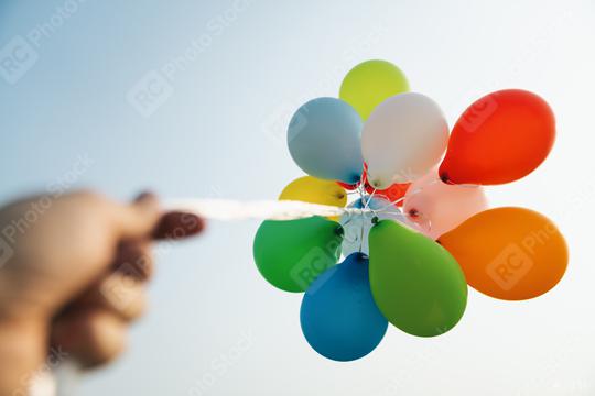 hand holding Colorful balloons at a funfair  : Stock Photo or Stock Video Download rcfotostock photos, images and assets rcfotostock | RC Photo Stock.: