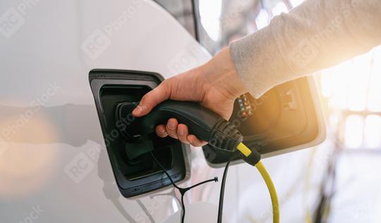 Hand holding Electric car charger. Power supply electric car charging for electric car technology transportation in the future.  : Stock Photo or Stock Video Download rcfotostock photos, images and assets rcfotostock | RC Photo Stock.: