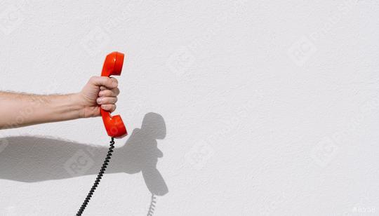 hand holding Red telephone receiver with copy space  : Stock Photo or Stock Video Download rcfotostock photos, images and assets rcfotostock | RC Photo Stock.: