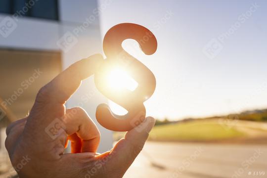 Hand holds paragraph as a sign of justice and Iustitia / Justitia the Roman goddess of Justice  : Stock Photo or Stock Video Download rcfotostock photos, images and assets rcfotostock | RC-Photo-Stock.: