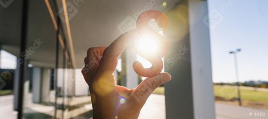 Hand holds paragraph as a sign of justice and Iustitia / Justitia the Roman goddess of Justice  : Stock Photo or Stock Video Download rcfotostock photos, images and assets rcfotostock | RC Photo Stock.: