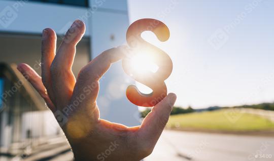 Hand holds paragraph in the sun as a sign of justice   : Stock Photo or Stock Video Download rcfotostock photos, images and assets rcfotostock | RC Photo Stock.: