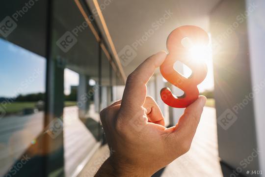 Hand holds paragraph in the sun as a sign of justice and law  : Stock Photo or Stock Video Download rcfotostock photos, images and assets rcfotostock | RC Photo Stock.: